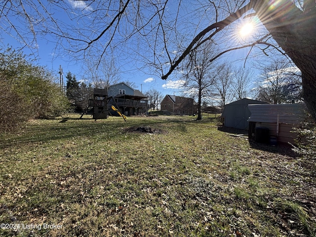 view of yard with a storage shed and a wooden deck