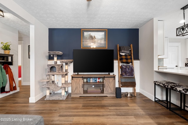 living room with hardwood / wood-style flooring and a textured ceiling