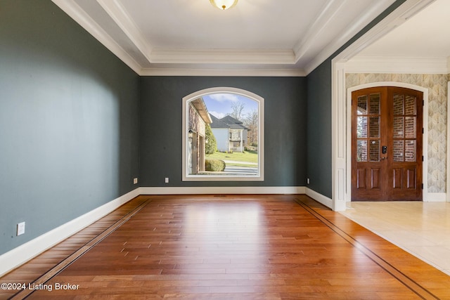 unfurnished room featuring hardwood / wood-style floors, french doors, and ornamental molding