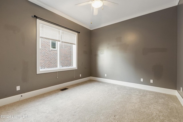 carpeted empty room featuring ceiling fan and ornamental molding