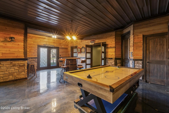 recreation room with bar area, french doors, wooden ceiling, and wooden walls