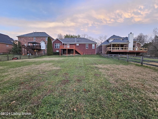 yard at dusk with a deck