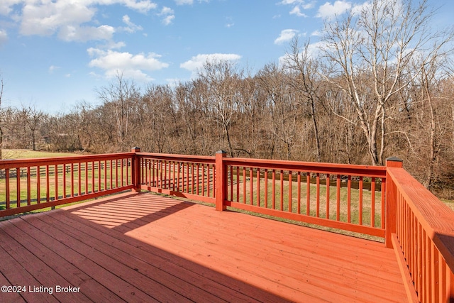 wooden terrace featuring a lawn