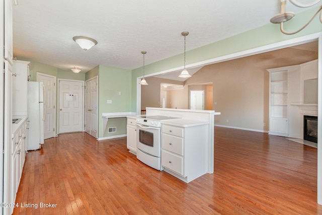 kitchen featuring white cabinetry, pendant lighting, white appliances, a kitchen island, and light wood-type flooring