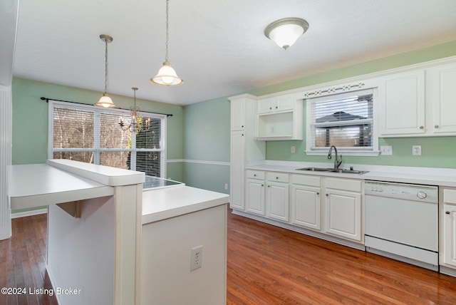 kitchen with sink, white dishwasher, pendant lighting, wood-type flooring, and white cabinets