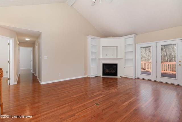 unfurnished living room with hardwood / wood-style floors, beamed ceiling, and high vaulted ceiling