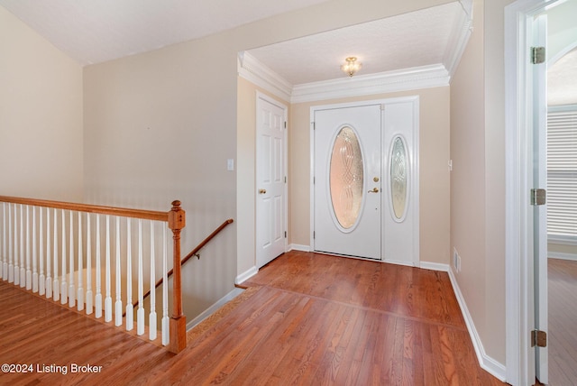 foyer entrance featuring hardwood / wood-style floors and ornamental molding