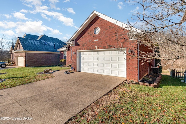 view of side of home with a yard