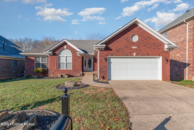 view of front of house with a front yard and a garage