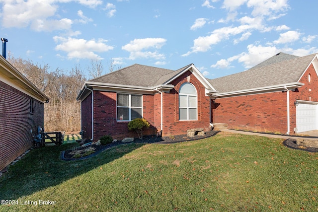 view of front of property with a front yard and a garage