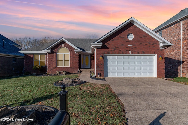 view of front of home with a lawn and a garage