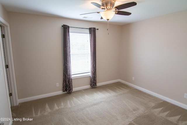 unfurnished room featuring light colored carpet and ceiling fan