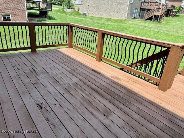 wooden terrace with a yard