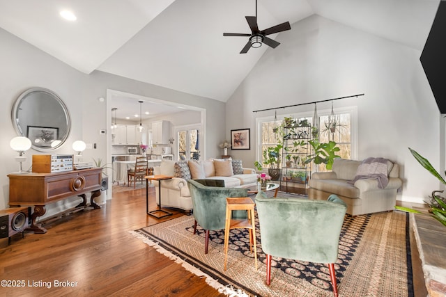 living room with ceiling fan, high vaulted ceiling, and hardwood / wood-style flooring