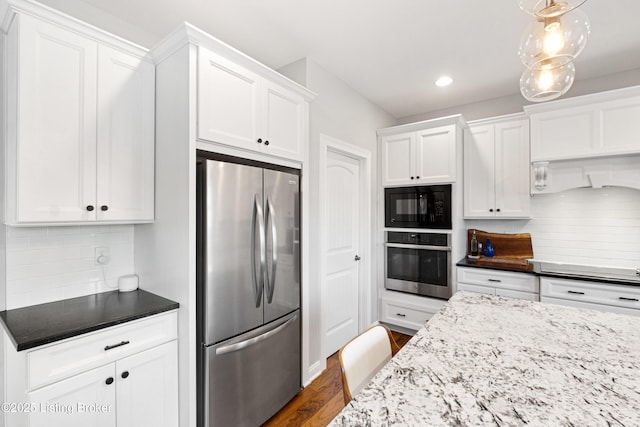 kitchen featuring stainless steel appliances, white cabinetry, decorative backsplash, light stone countertops, and dark hardwood / wood-style flooring