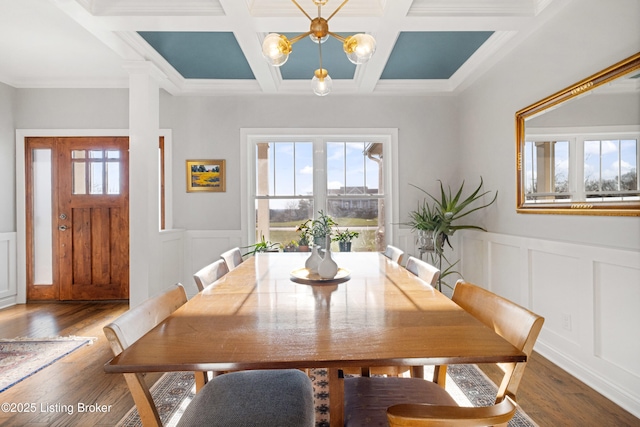 dining room with dark hardwood / wood-style flooring, beam ceiling, ornamental molding, and coffered ceiling