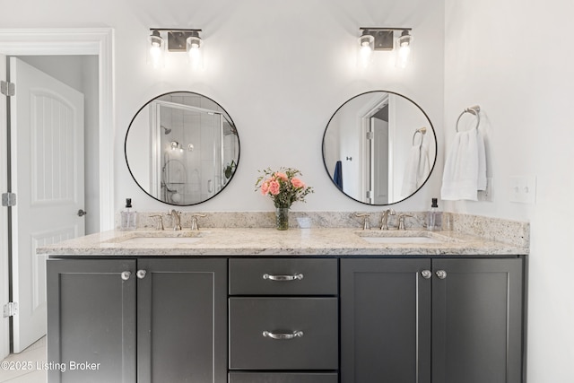 bathroom featuring a shower with door, tile patterned flooring, and vanity