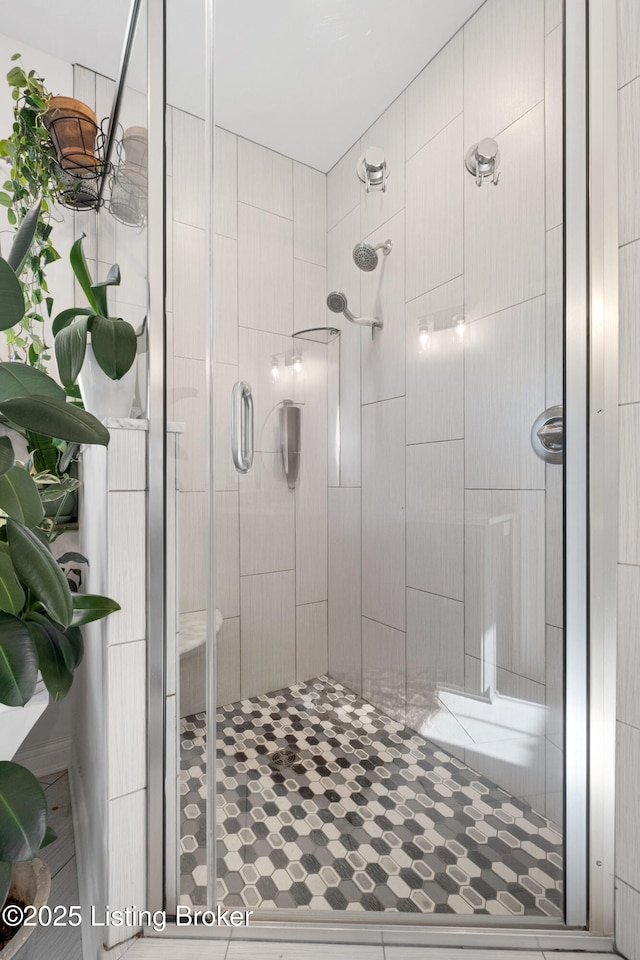 bathroom featuring a shower with shower door