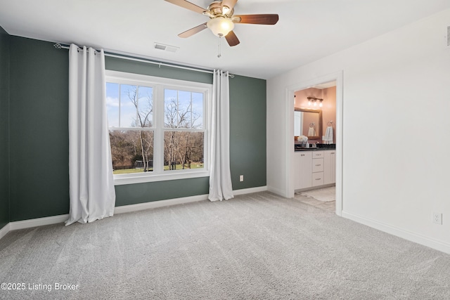 carpeted empty room with a healthy amount of sunlight and ceiling fan