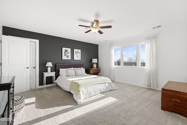 carpeted bedroom with ceiling fan and a closet