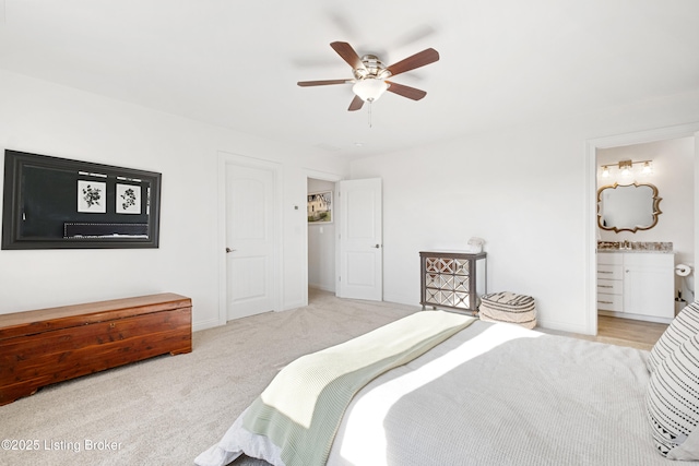 bedroom featuring ceiling fan, ensuite bathroom, and light carpet