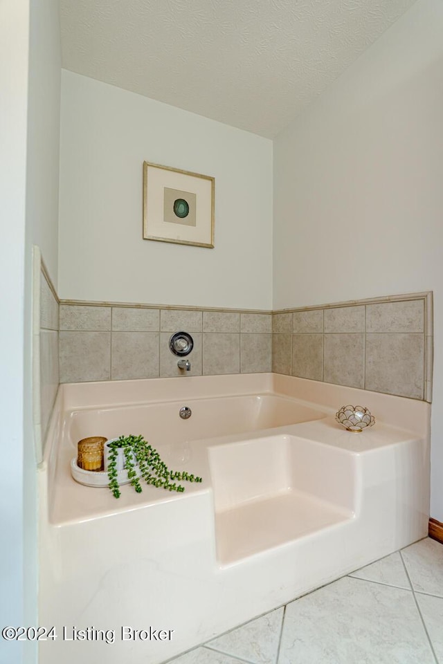 bathroom featuring tile patterned flooring and a textured ceiling