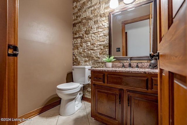 bathroom featuring vanity, tile patterned floors, and toilet