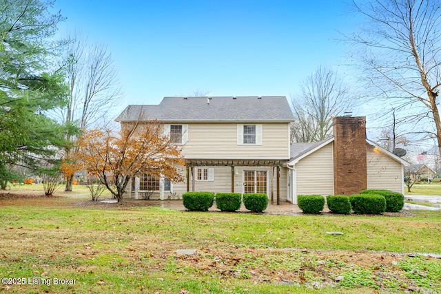 rear view of property featuring a yard