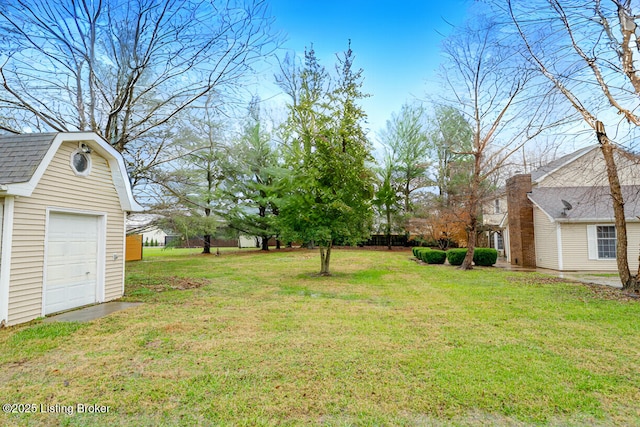 view of yard featuring a garage and an outdoor structure