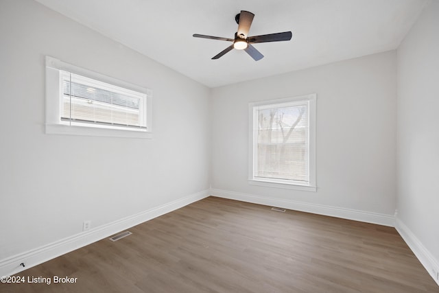 empty room featuring hardwood / wood-style floors and ceiling fan