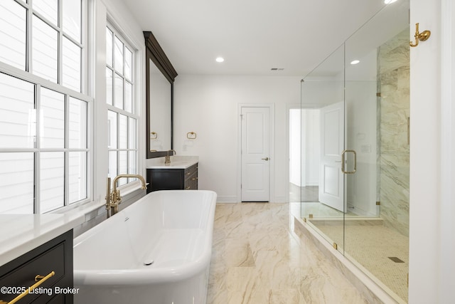 bathroom with vanity and independent shower and bath