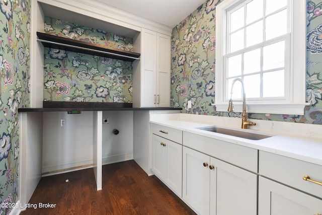 interior space featuring dark hardwood / wood-style floors, white cabinetry, sink, and a wealth of natural light