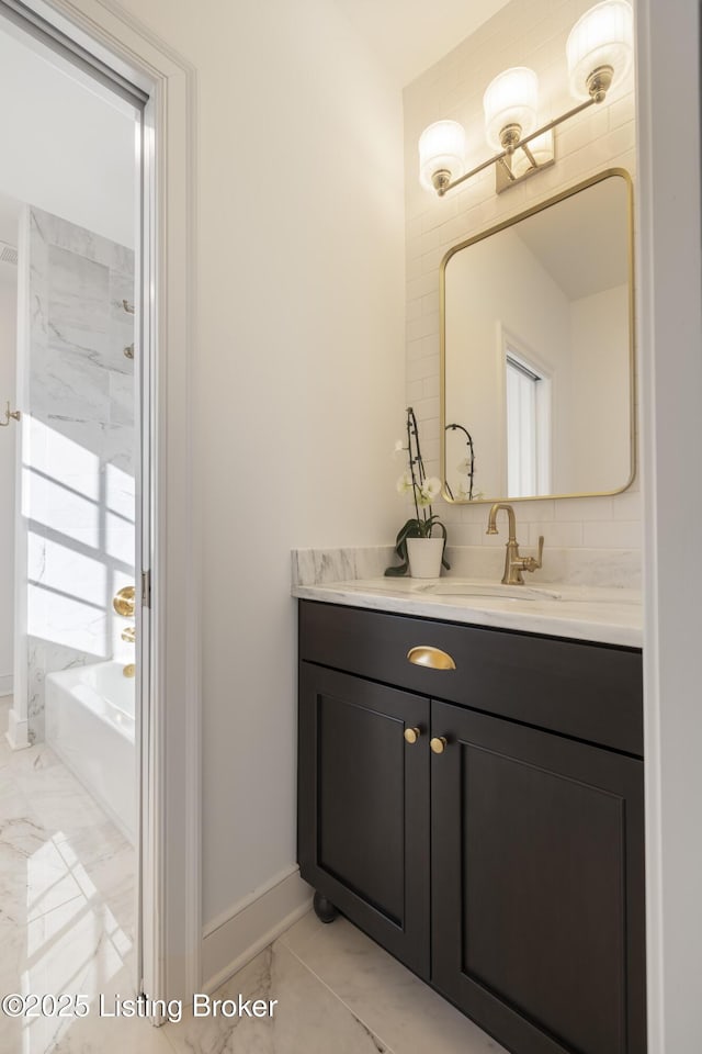 bathroom with a tub and vanity