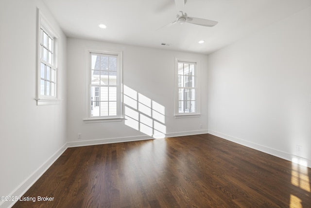 unfurnished room with ceiling fan, dark hardwood / wood-style flooring, and plenty of natural light