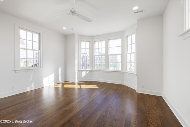 empty room with dark hardwood / wood-style floors and ceiling fan