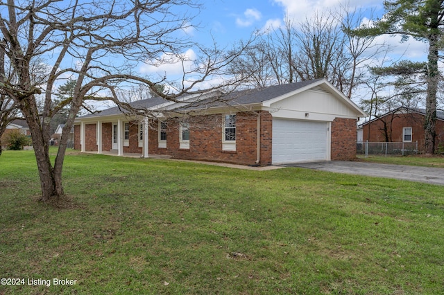 single story home with a front yard and a garage