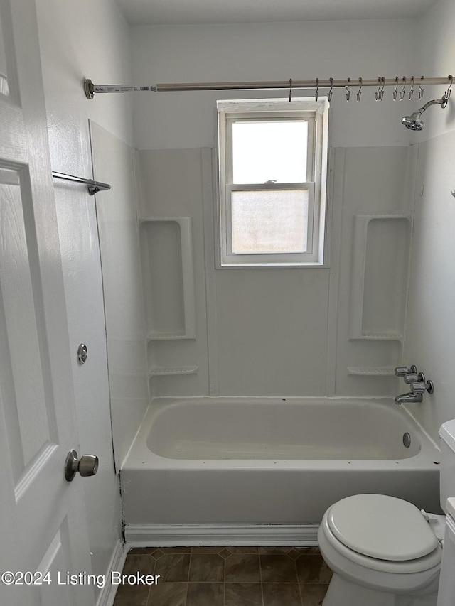 bathroom featuring shower / bathing tub combination, toilet, and tile patterned floors