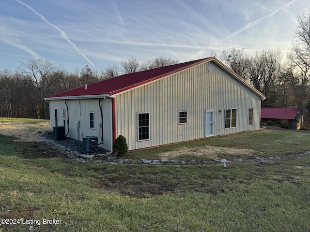 exterior space featuring a yard and central AC