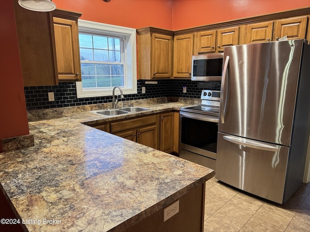 kitchen with tasteful backsplash, sink, light tile patterned floors, and stainless steel appliances