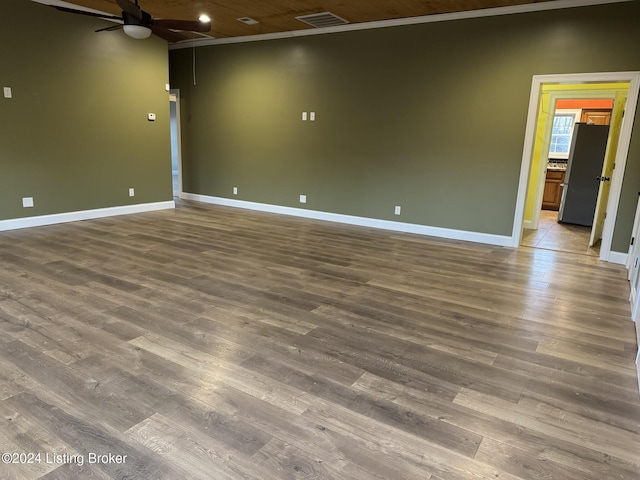 unfurnished room with ceiling fan, dark hardwood / wood-style flooring, and ornamental molding