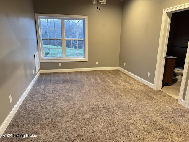 carpeted empty room with ceiling fan