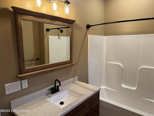 bathroom featuring vanity and shower / bath combination