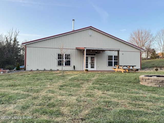 rear view of house with a yard and french doors