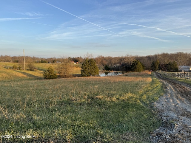 view of yard with a water view and a rural view