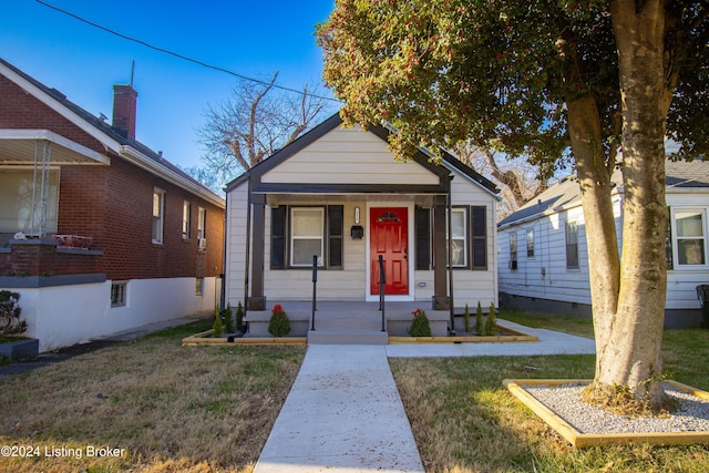 bungalow-style house with a front lawn