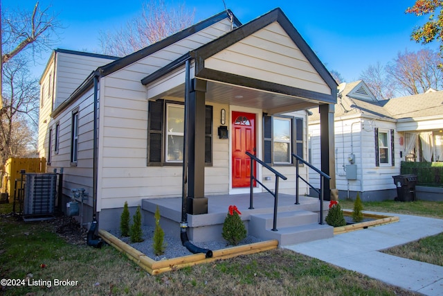 bungalow-style home with cooling unit and covered porch