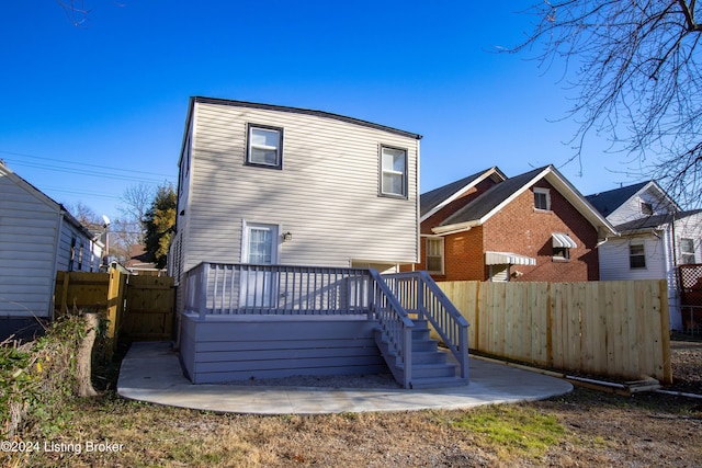 back of property with a wooden deck