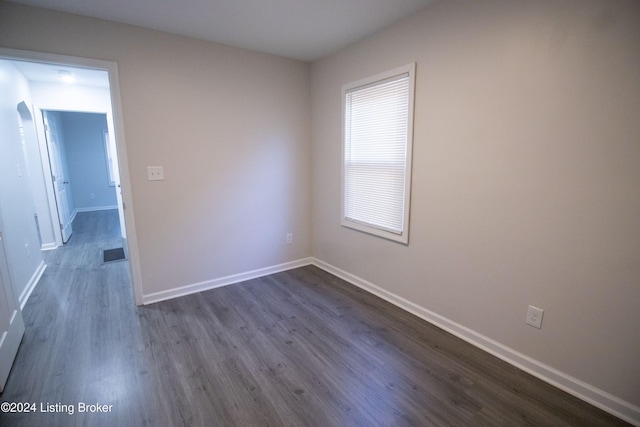 empty room featuring dark wood-type flooring