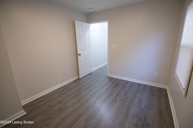 unfurnished room featuring dark hardwood / wood-style floors