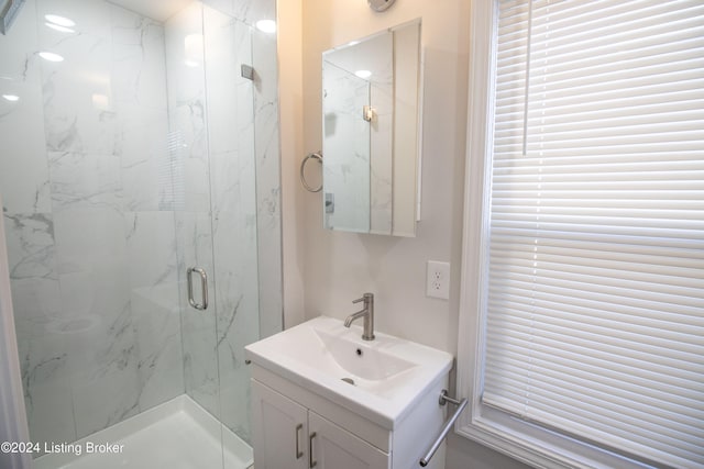 bathroom with vanity and a shower with shower door